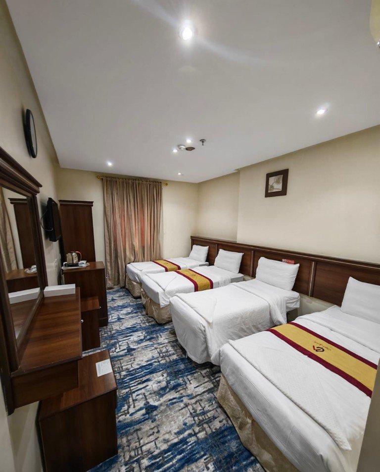 Guest room with four single beds